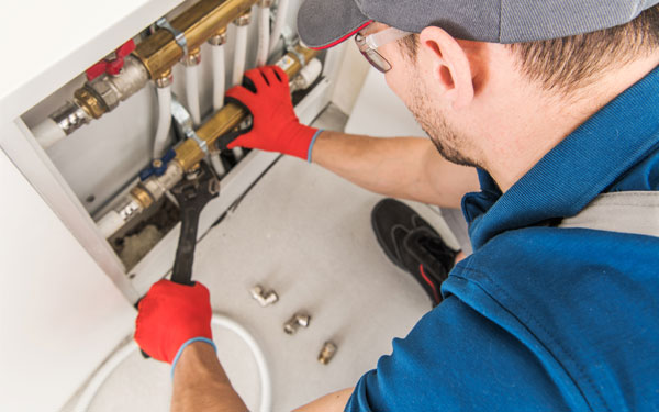 Plumber fixing radiant floor heating